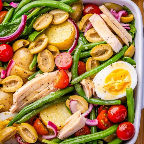 Nicoise salad in a white dish.