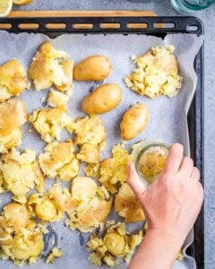 smashing the potatoes on a pan.