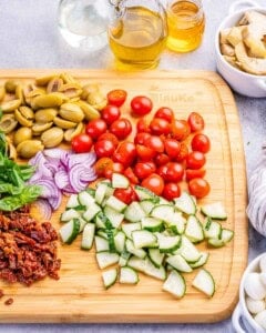 chopped veggies on a wooden board.
