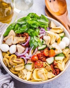 pasta ingredients added to a bowl.