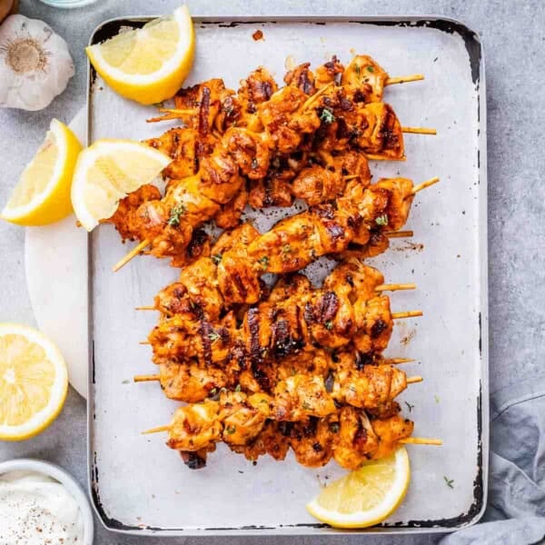 baked chicken skewers on a sheet pan.