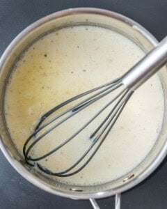 whisked bechamel sauce in a pan.
