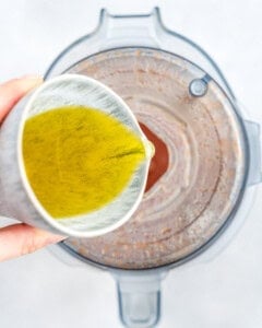 adding oil into the blender with all the catalina dressing.