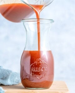 Catalina dressing is being poured into a jar.