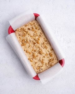 batter placed in a baking pan and topped with chopped walnuts.