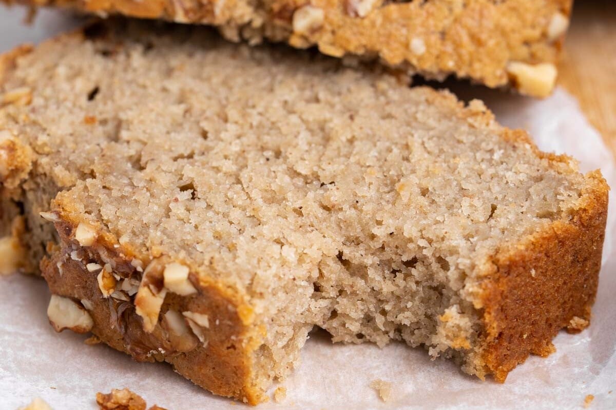apple sauce bread slice on a cutting board with a bite taken off.