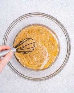mixing the apple sauce, egg, and oil batter.