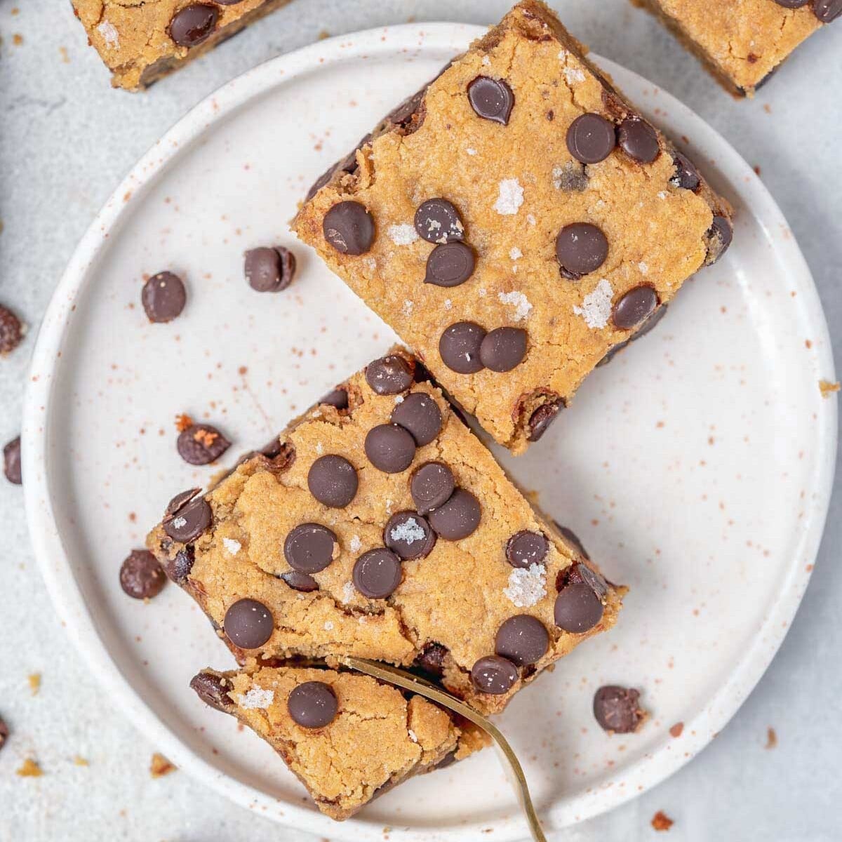 2 cookie bars on a plate with a fork grabbing a bite.