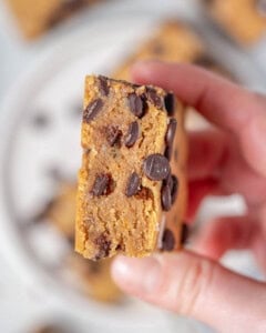 hand holding a cookie dough bar.