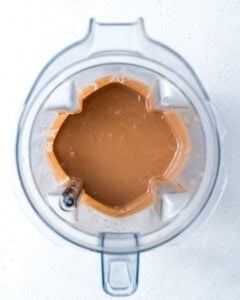 ingredients blended in a blender to make peanut butter chocolate protein shake.