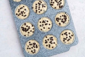muffin batter added to a baking pan.