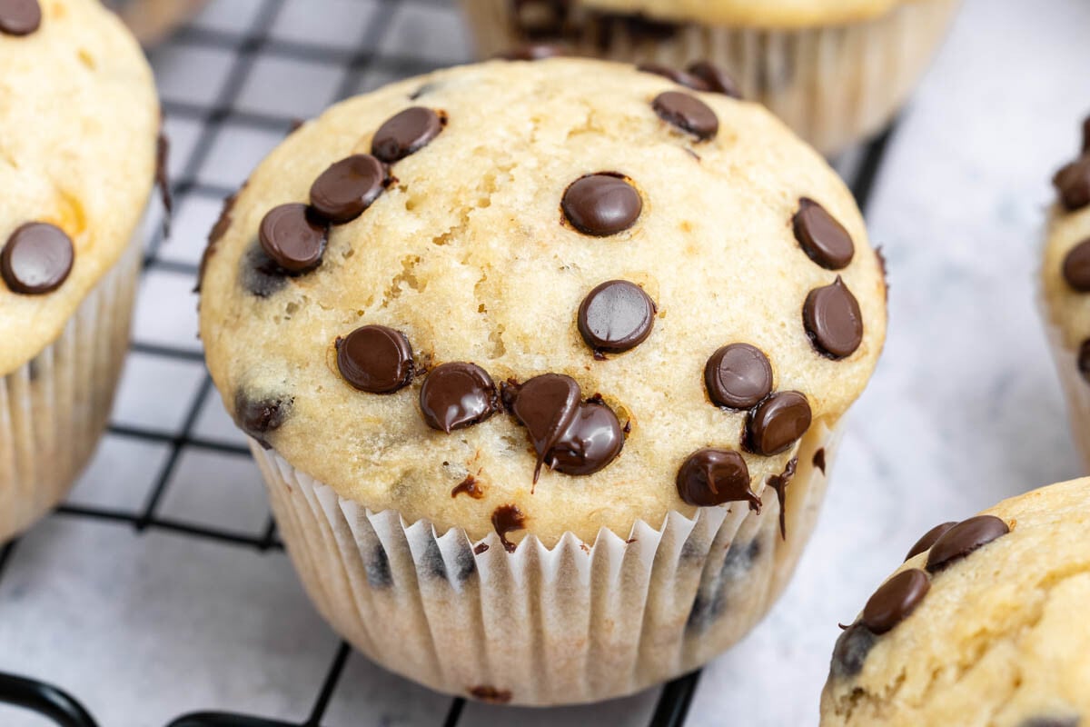 baked cottage cheese banana muffins with chocolate chips on a wire rack.