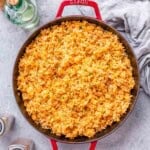 mexican rice cooked in a red skillet.