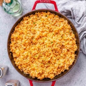 mexican rice cooked in a red skillet.