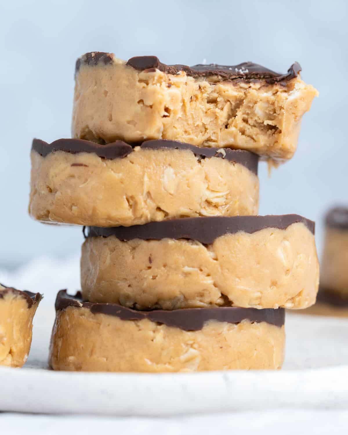 peanut butter cups stacked over each other with bite taken off the top one.