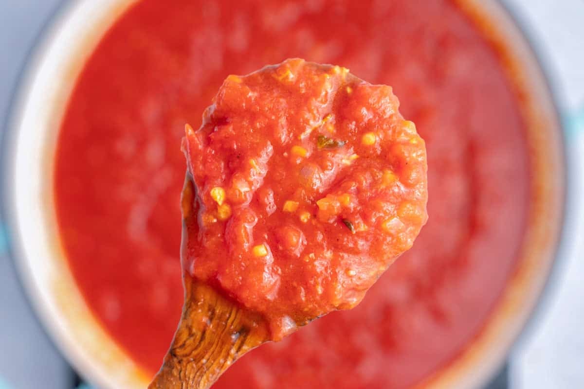 spoonful of arrabbiata over a pan.
