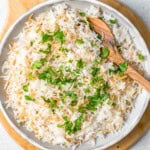 lebanese rice in a bowl topped with chopped parsley.