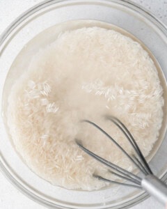 rice being soaked in a bowl.