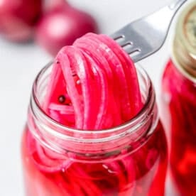 pickled red onions in a jar.