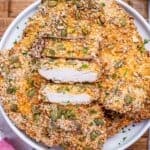 air fryer chicken cutlets in a bowl with one sliced into strips.