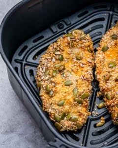 Seeded chicken cutlets in an air fryer.