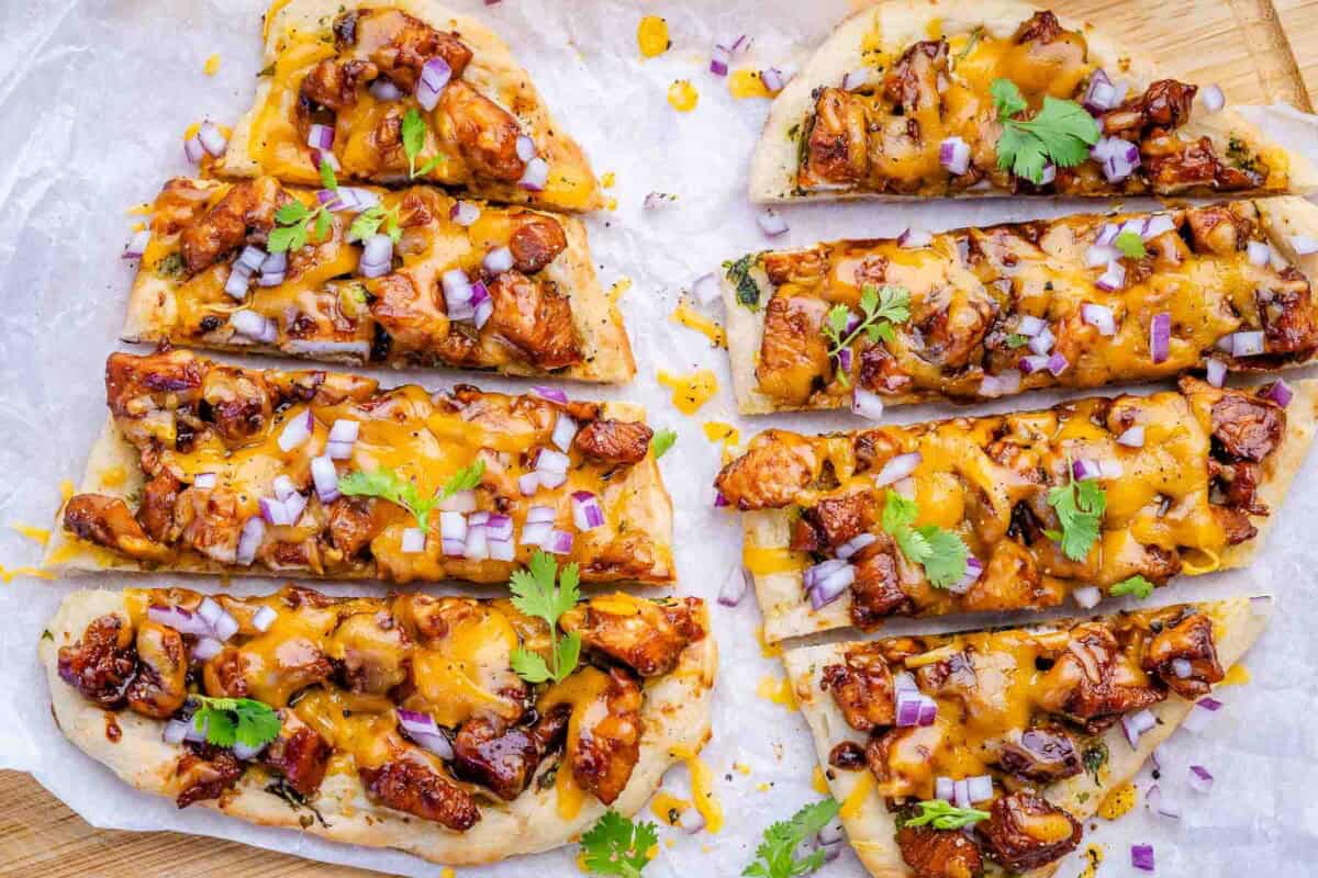 2 sliced bbq chicken flatbread next to each other.