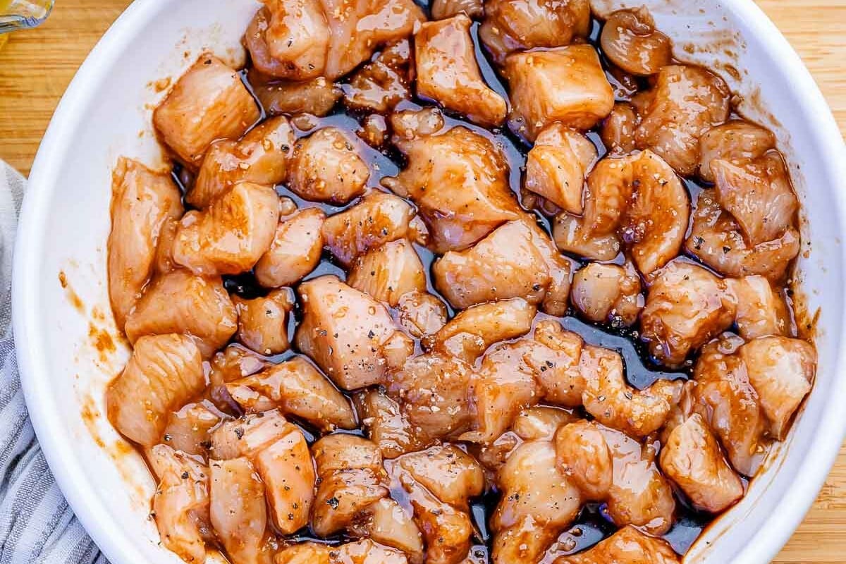 marinating chicken bites in a bow.