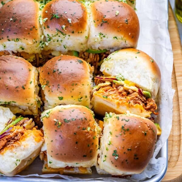 baked chicken sliders on parchment paper.