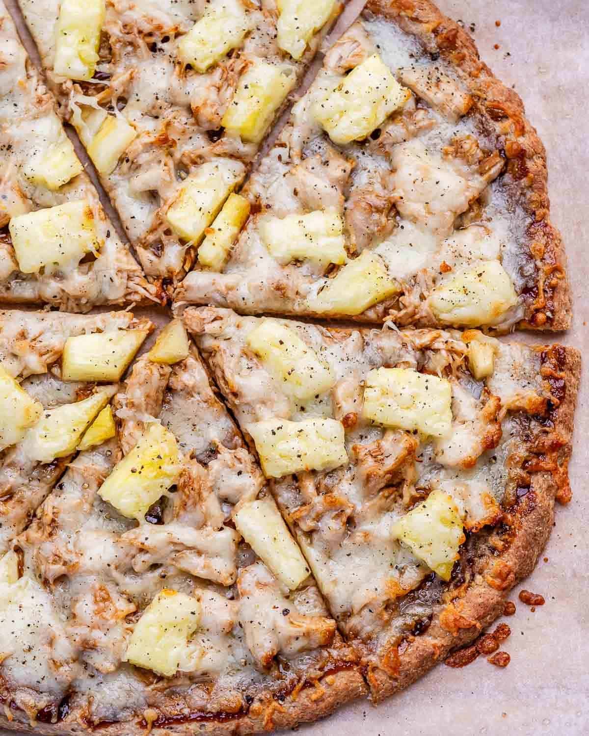 BBQ chicken pizza with pineapple chunks.