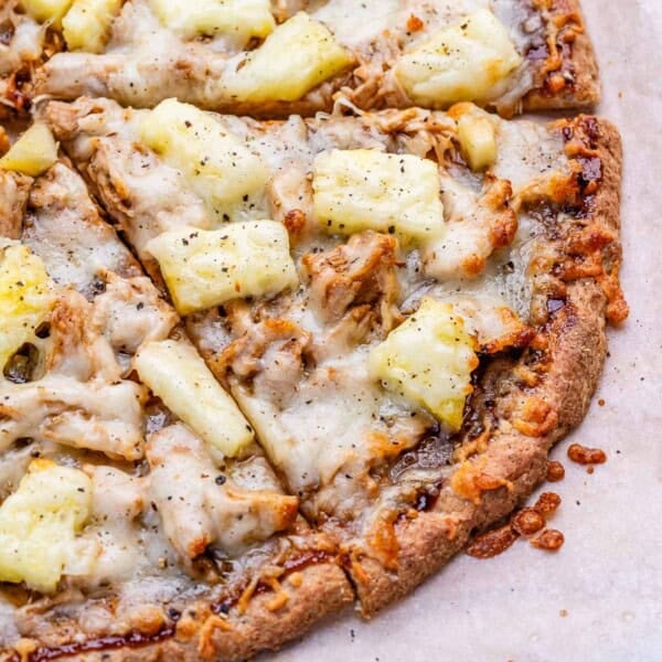bbq chicken pizza slices topped with pineapple and melted cheese.