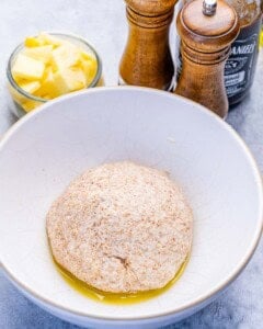 pizza dough ball in a bowl before baking.