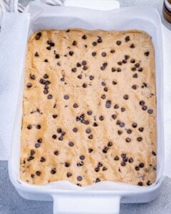 cookie dough added to a baking dish.