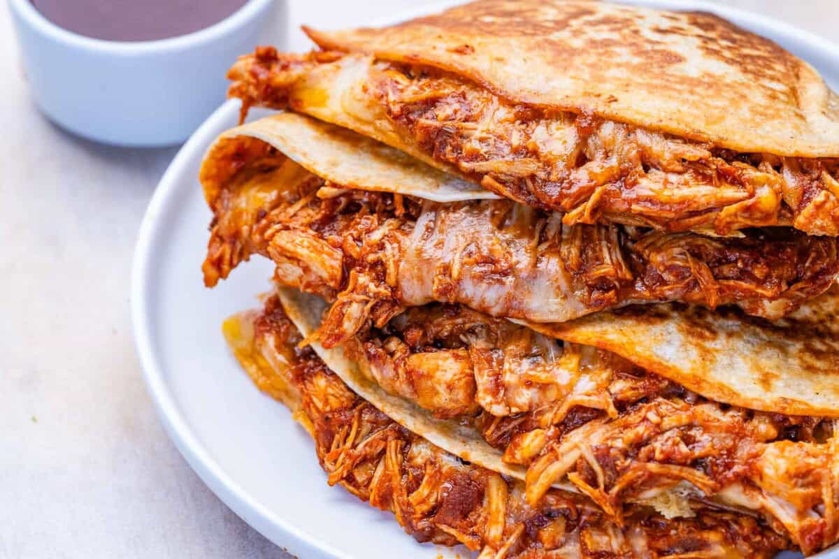 Chicken quesadilla, halved on a plate.
