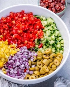 veggies chopped and placed in a bowl to make the pasta salad.