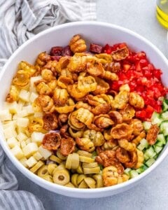 air fried pasta added over the chopped veggies in the bowl.