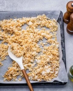 cooked and seasoned rice spread on a sheet pan.