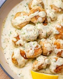 meatballs in a lemon sauce in a skillet.