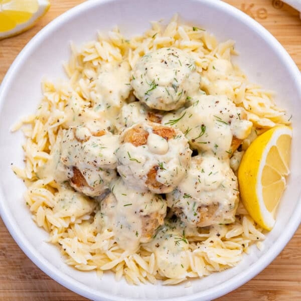 greek chicken meatballs cooked in a creamy sauce served over cooked orzo.