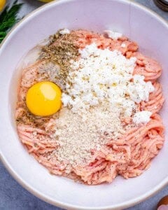 Ingredients to make the chicken meatballs in a bowl.