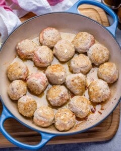 Cooked chicken meatballs in a pan.