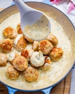 pouring the sauce over the chicken meatballs.