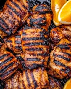 grilled chicken thighs on a pan next to each other.