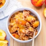 a bowl with peach dump cake.