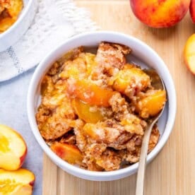 a bowl with peach dump cake.
