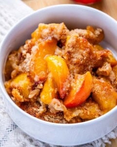 A white bowl of peach dump cake