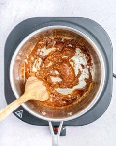 Cooking the seasonings in a saucepan.