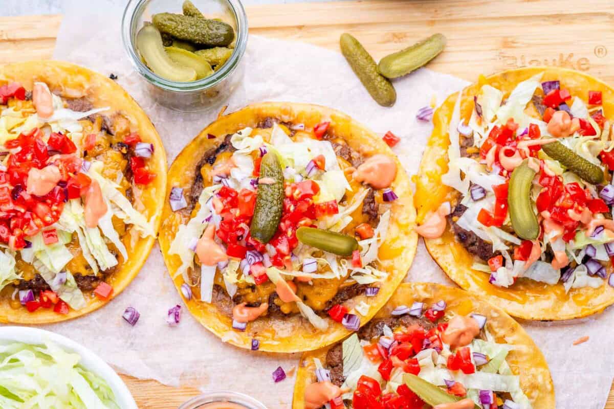 smash burger tacos on a cutting board.