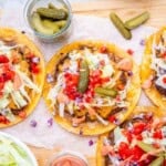 smash burger tacos laid out with burger toppings.