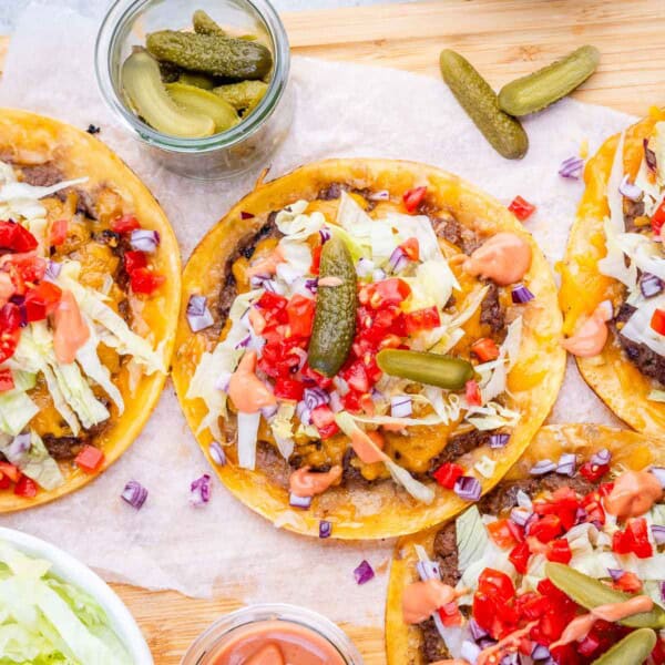 smash burger tacos laid out with burger toppings.
