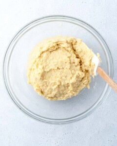 almond flour lemon cake batter added to a bowl.